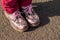 Pair of childs floral print boots on a grey background, isolated. Fashion for spring or autumn. Leather shoes for girl