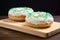 a pair of classic ring donuts centered on a teal board