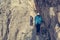 Pair of climbers walking on narrow ledge.