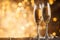 A pair of clinking champagne glasses in front of a shimmering glitter background, ideal for New Year\\\'s Eve and holiday