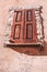 Pair of closed, brown, wood shutters on a residencial structure in Provence, France