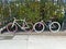 Pair of colorful bicycles parked locked to the fence