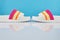 Pair of colorful multicolored rainbow flip flops or sandals on pastel background. Beach holidays and Summer concept