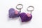 A pair of crocheted purple heart-shaped keyring.
