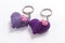 A pair of crocheted purple heart-shaped keyrings.