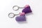 A pair of crocheted purple heart-shaped keyrings.