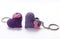 A pair of crocheted purple heart-shaped keyrings.