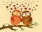 A pair of cute owlet sitting on a branch. Owls in love hearts