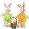 A pair of cute toy soft hares and a basket of Easter eggs