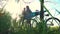 A pair of cyclists sit in a hammock on a sunny afternoon after a walk