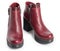 Pair of dark red womens leather boots isolated on a white background