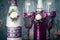 A pair of decorative purple champagne bottles and glasses for the bride and groom