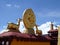 A pair of deer flanking the eight-spoked Dharma wheel on lotus flower, on the roof of Jokhang Monastery, Lhasa, Tibet