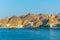 a pair of dhows - traditional arab ships - is heading to the sea from Muttrah part of Muscat dominated by a fort on a hill, Oman