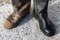 A pair of different boots. Contrast old and new, clean and dirty shoes close-up