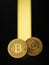 A pair of digital coins in a beam of bright light on a black background. The concept of the rise in the price of cryptocurrency