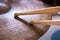 Pair of drumsticks lying on cymbal.