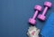 Pair of dumbbells, sports gloves and blue towel