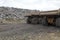 Pair of dump trucks in gravel