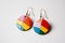 pair of Earrings Lgbtq rainbow color jewelry isolated on soft background illustration generative ai