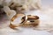 A pair of elegant gold wedding rings, placed side by side on a wooden table, creating a symbol of eternal love and lifelong