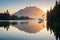 A pair of elegant swans gliding gracefully on a calm, reflective lake at sunrise