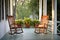 pair of empty rocking chairs on a porch