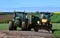 Pair of Farm Tractors on Farmland Ready for Work