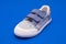 Pair of fashion denim baby shoes for the toddlers feet. Kids sneakers isolated on blue background.