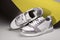 Pair of fashion sneakers shoes in ultimate gray and illuminating yellow colors of the year 2021