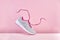 Pair of fashion stylish sneakers with flying laces, Running sports shoes on pink background