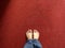 Pair of feet on a red carpet