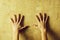 Pair of female hands on abstract cement wall