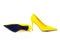 Pair of female yellow suede stiletto heel shoes on white background