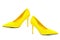 Pair of female yellow suede stiletto heel shoes on white background