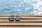 Pair of flip flops on the wooden dock and scenery of lake river at natural background