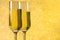 A pair of flutes of champagne golden abstract background