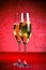 A pair of flutes of champagne on red abstract background