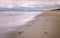 Pair of foot prints on a deserted beach on cloudy evening