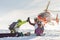 Pair of freeriders of snowboarders give five when the helicopter lands