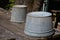 Pair of galvanized buckets on a wood table, selective focus, creative copy space