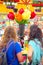 Pair of girls looks the giant tulips at Bloemenmarkt Amsterdam