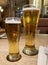 Pair glasses of beer on wooden table
