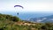 A pair of gliders flying over the mountains and sea