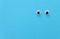 Pair googly eyes over blue background