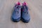 Pair of gray new womens trekking shoes with pink trim, tied with laces, concept of comfortable sports shoes for jogging and life