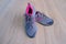 Pair of gray new womens trekking shoes with pink trim, tied with laces, concept of comfortable sports shoes for jogging and life