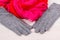 Pair of gray warm womanly gloves and colorful shawl for using in autumn or winter