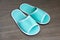 A pair of green disposable slippers with soft foam texture for i