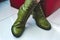 A pair of green leather women`s boots with shoelaces and heels